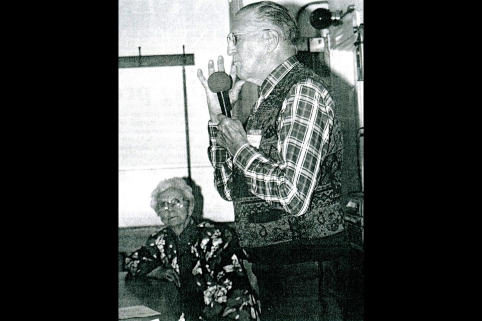 Jim Conly speaking at a seniors' rally with Edna Foster looking on, from Oct. 2002.