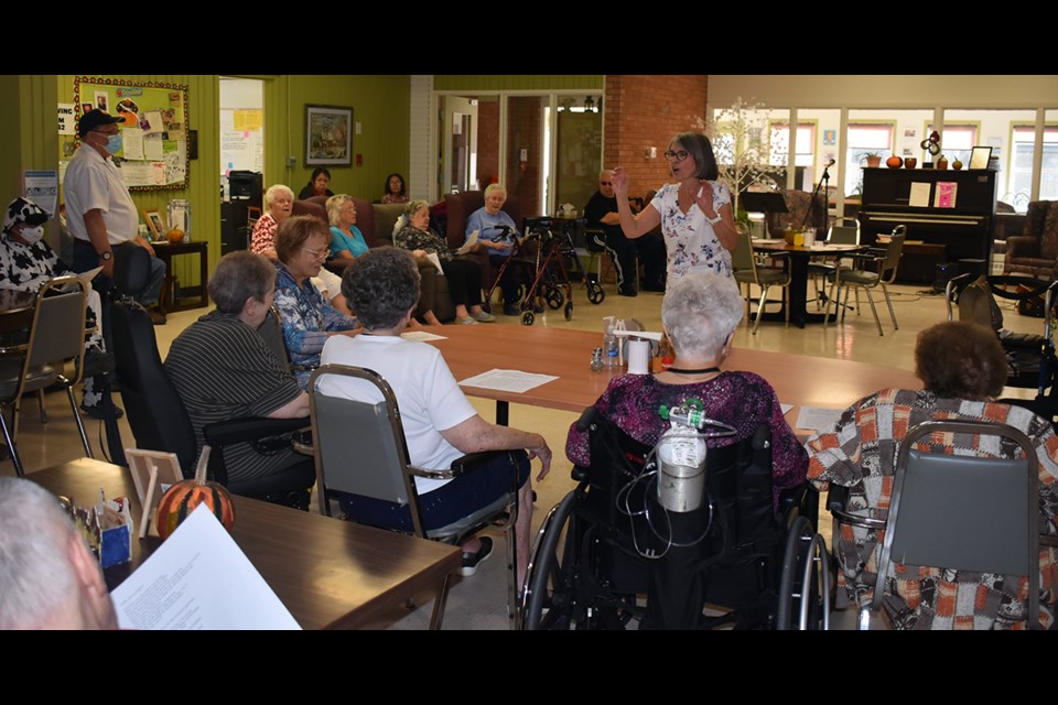 Susan Bear encouraged Eaglestone Lodge residents to raise their voices in song during a get-together Oct. 19.