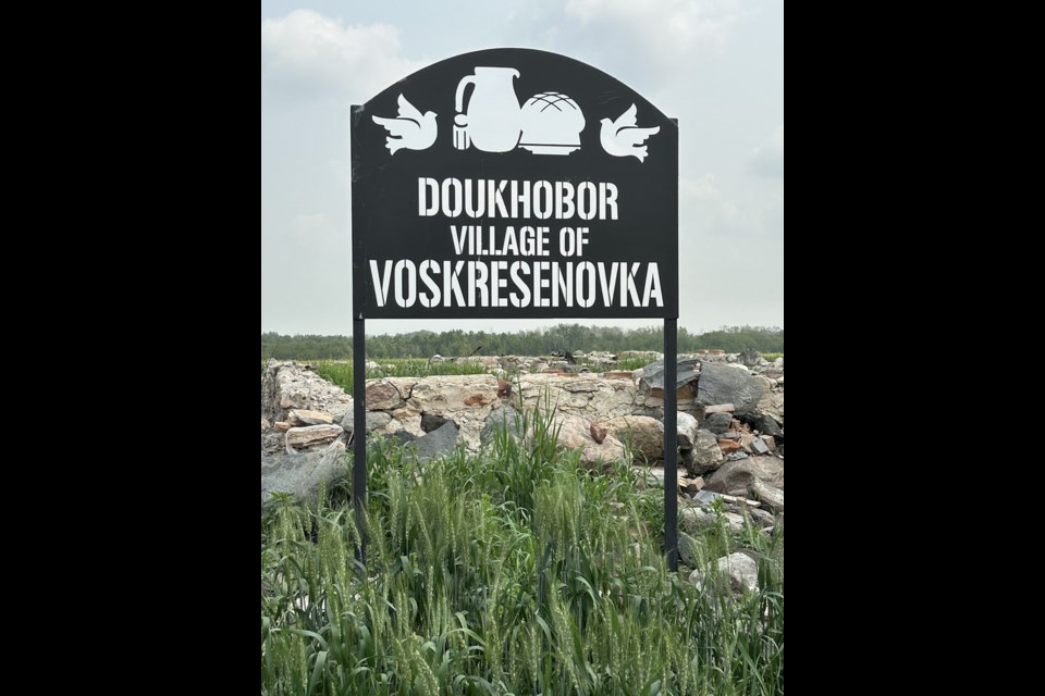 A seven-foot-high iron sign identifies the site of the Doukhobor village of Voskresenovka.

