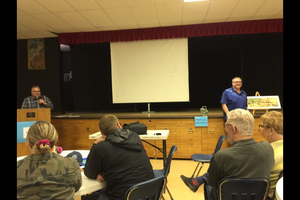 Tom Redhead and Jamie Brandrick auctioning off a Hynde painting during an event to remember Borden's flood of 2013.