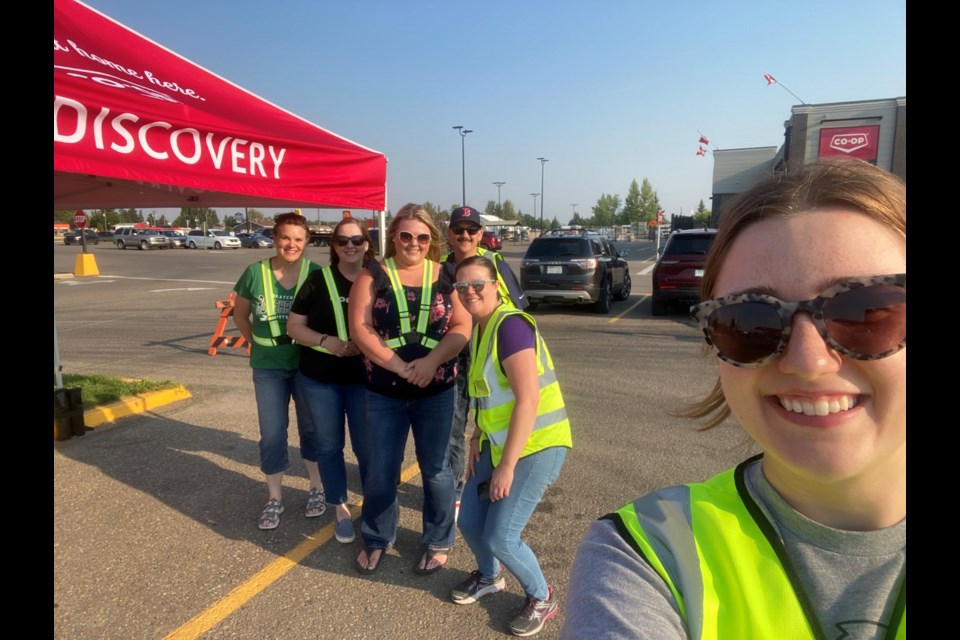 Discovery Co-op staff welcoming moviegoers to the Co-op Mall parking lot.