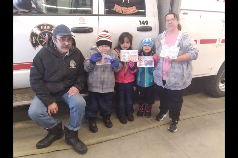 Among Victoria School kindergarten students to tour the James Rudd Fire Hall in Kamsack on Feb. 26, which was Pink Shirt Day, were Kadence Campeau, Kylie Manguera and Khloe Quambia. At left is Ken Thompson, fire chief, and at right is their teacher, Keri Lindsay.