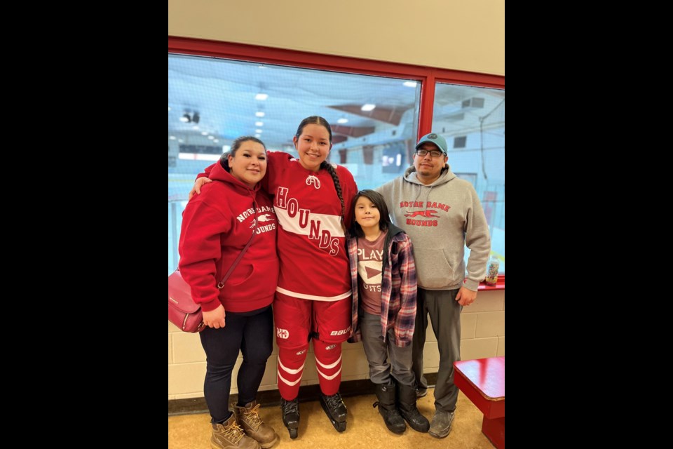 Cameron Halkett (centre) stands with her mom Kimberly Halketts and dad Stuart Halkett and little brother Chael Halkett after one of her hockey games last season. 