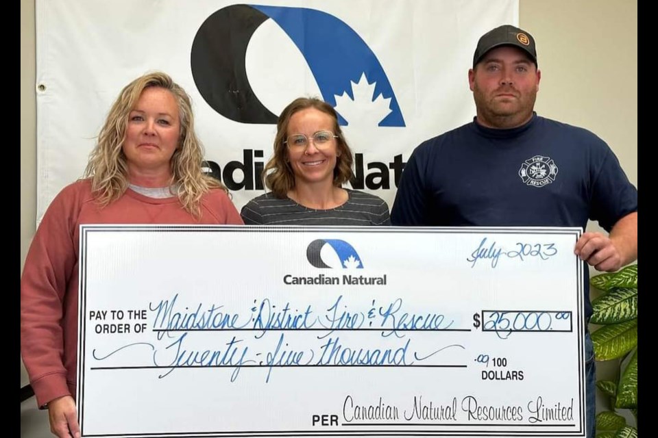 Cora Lambkin and Lisa Gauld of Canadian Natural Resources Limited present a $25,000 donation to Brent Olson of Maidstone Waseca and District Fire and Rescue. 