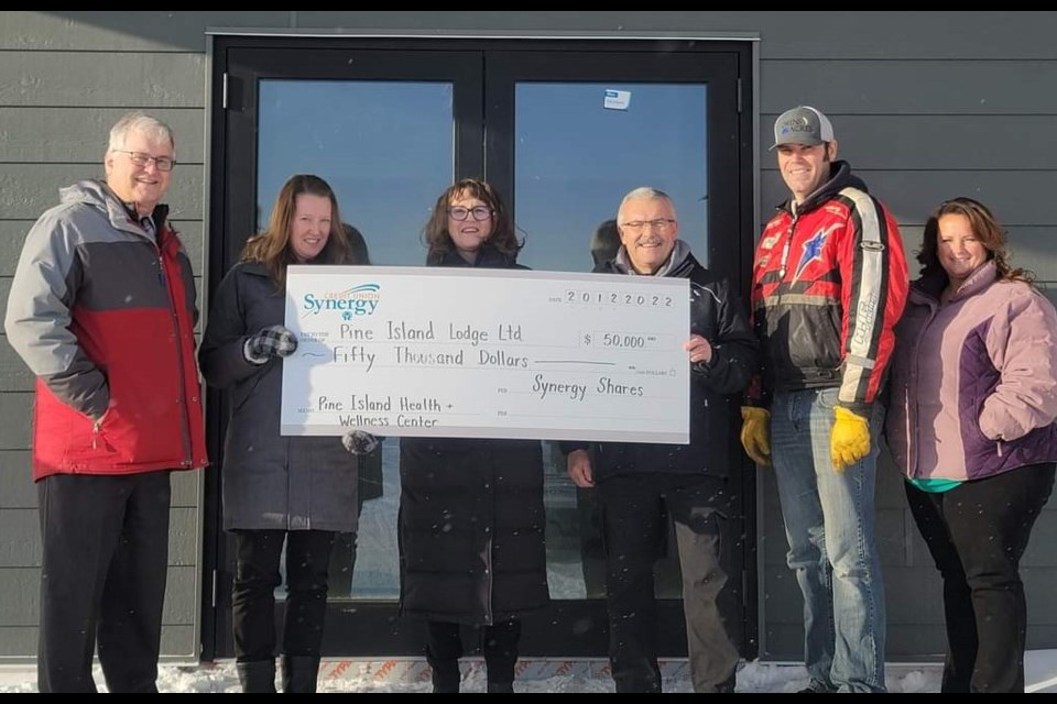 A $50,000 Synergy Shares donation is presented to Brenda Marfleet, Gerry Sielsky, Scott Owens and Michelle Buechler of Pine Island Lodge Ltd. by Jody Zerr and John Veenstra of Synergy Credit Union. 