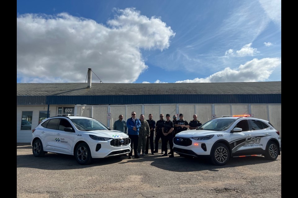 North Battleford Fleet Services staff with two new hybrid vehicles acquired for use in the city.