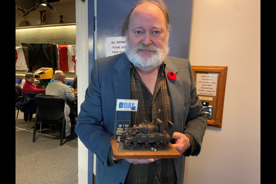 Doug Keall, a retiree from North Battleford, holds a detailed army model he spent three months crafting, outside the Legion’s lunchroom Monday Nov. 11. 