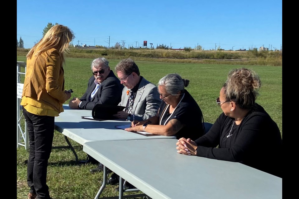 Mayor David Gillan and Sweetgrass First Nation Chief Lorie Whitecalf signing the urban reserve agreement on Sept. 27 at the corner of Railway Avenue and the Highway 16 Bypass in North Battleford. “I’m the third mayor that worked on this project, Randy (Patrick), he’s the third city manager that’s worked on this project as well, and there have been another 18 councillors in the last 14 years,” Gillan said. 