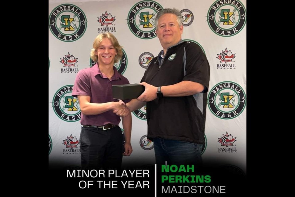 Noah Perkins receives the Saskatchewan Minor Player of the Year award from a Saskatchewan Baseball Association representative.