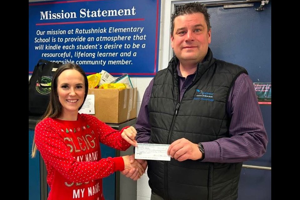 On behalf of Maidstone Community Calendar, Megan Rhinehart presents a $2,460 cheque to Brennan Becotte, principal for Ratushniak Elementary School’s Breakfast/Lunch Program. 