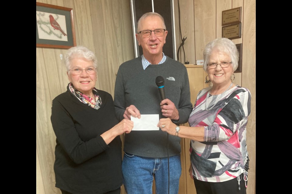 Passing the Christmas gift .  Joan Rice treasurer  of the dance club , David Sharpe president of the Duplicate Bridge Club. and Rita Rose. president of the N.B Old Time Dance Club. The senior dance club received a cheque for $1,000 from the North Battleford Duplicate Bridge Club as a gift at Pioneer Hall in North Battleford Nov. 27. 