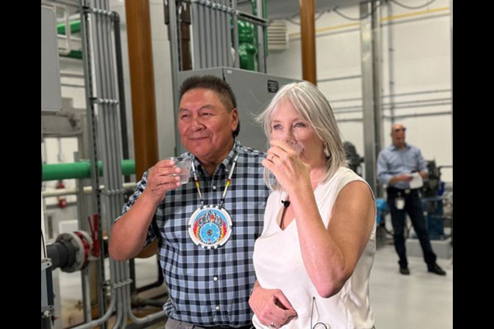 Star Blanket Cree Nation Chief Michael Starr (left) and Patty Hajdu, Minister of Indigenous Services, drink water from the new water treatment plant at Star Blanket Cree Nation