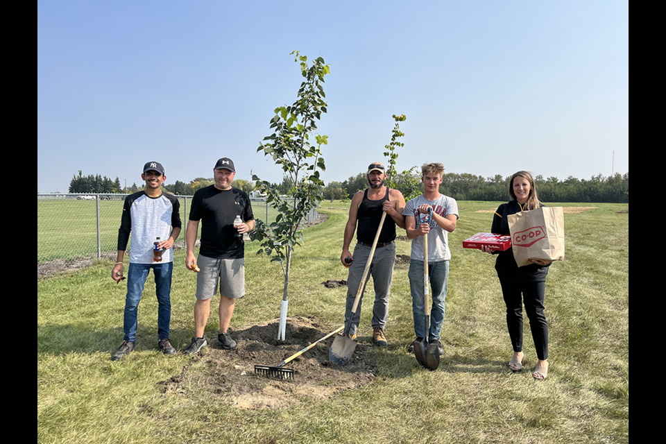 From left: planting trees for Town of Canora public works at the Canora Sports Grounds on Aug. 29 were: Priyank Patel, Aaron Herriges (director of leisure services), Kris Currie and Bronson Heshka. Kristin Olson of Crossroads Credit Union, right, stopped by with cold drinks and donuts “for the hard-working dedicated workers.” The Town received grant funding from the Crossroad Community Investment Fund for $5,000 and $10,000 through the Government of Saskatchewan's Municipal Economic Enhancement Program. Herriges said the 210 trees planted are a welcome addition to “naturalize the sportsgrounds to give it more of a park atmosphere, while creating a much needed shelterbelt to reduce erosion and provide shade. The hope is to add more eventually, but this is a great start. At full maturity some will reach as high as 80 feet, but many will mature at 40 feet high with wingspan or 30 feet.”