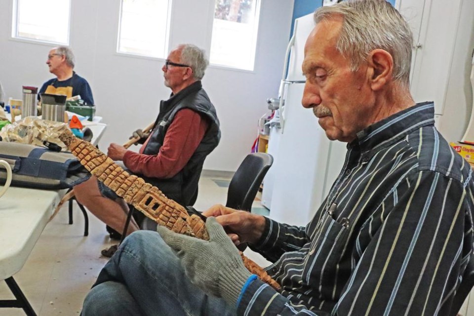 Jim Linnell of the Weyburn Carvers group worked on a carving he was doing with a thick piece of bark from a willow tree at a recent gathering of the group.