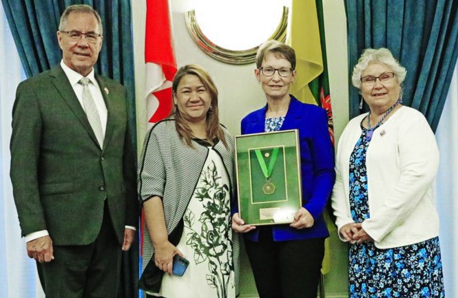 Lieutenant Governor Russ Mirasty, left, and his wife Donna, presented a Saskatchewan Literacy Award of Merit to Donna Hartley of Ogema, shown with Carmen Ocampo, her nominator. This was one of a number of literacy awards presented at a ceremony held at Government House in Regina on May 14.