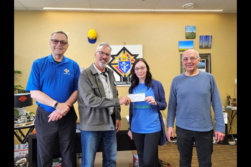 George Anderson and Ray Boutin with the Moose Mountain Knights of Columbus presented a cheque to Raven Daer and David Wakefield of Envision Counselling and Support Centre in memory of Knights member Jack Laderoute. 
