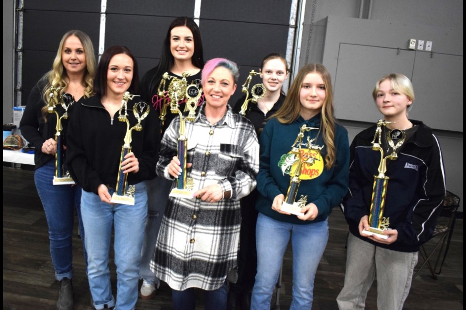 Women were recognized for hunting skills using a rifle. 