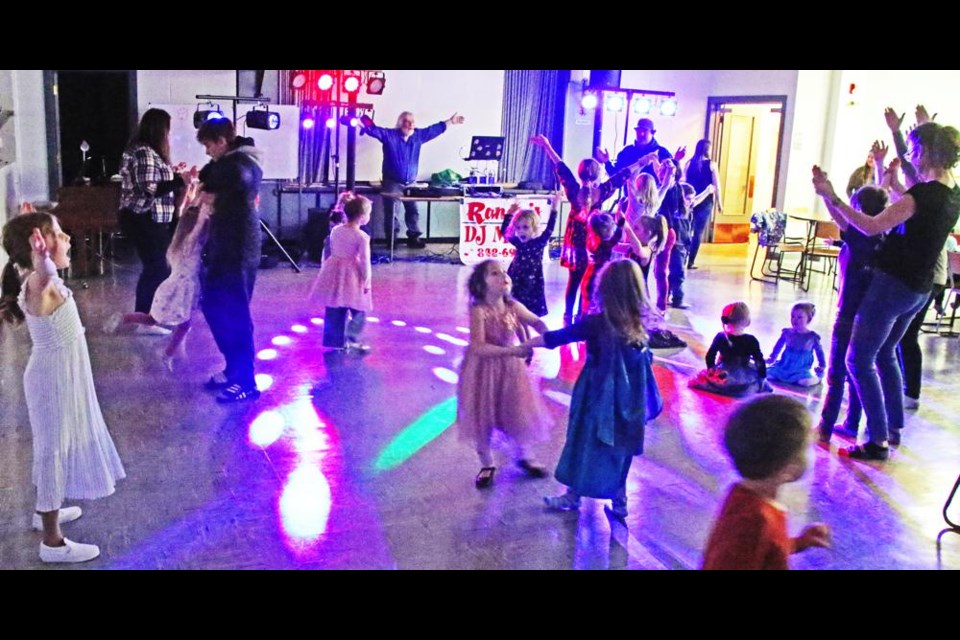 DJ Randy Bakaluk had the kids and parents doing the actions for the "YMCA" song, during the Valentine's Dance for the Weyburn Co-operative Playschool on Wednesday evening.