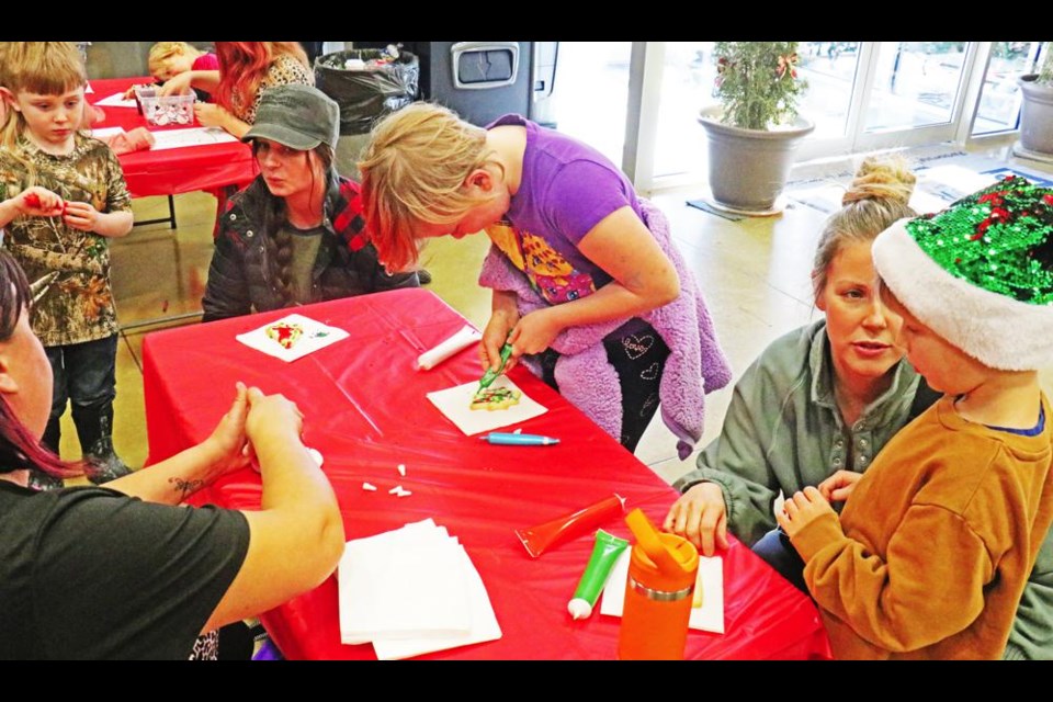 Moms and kids worked on fun craft activities at the Festival of Trees on Tuesday, put on by the Family Place staff.