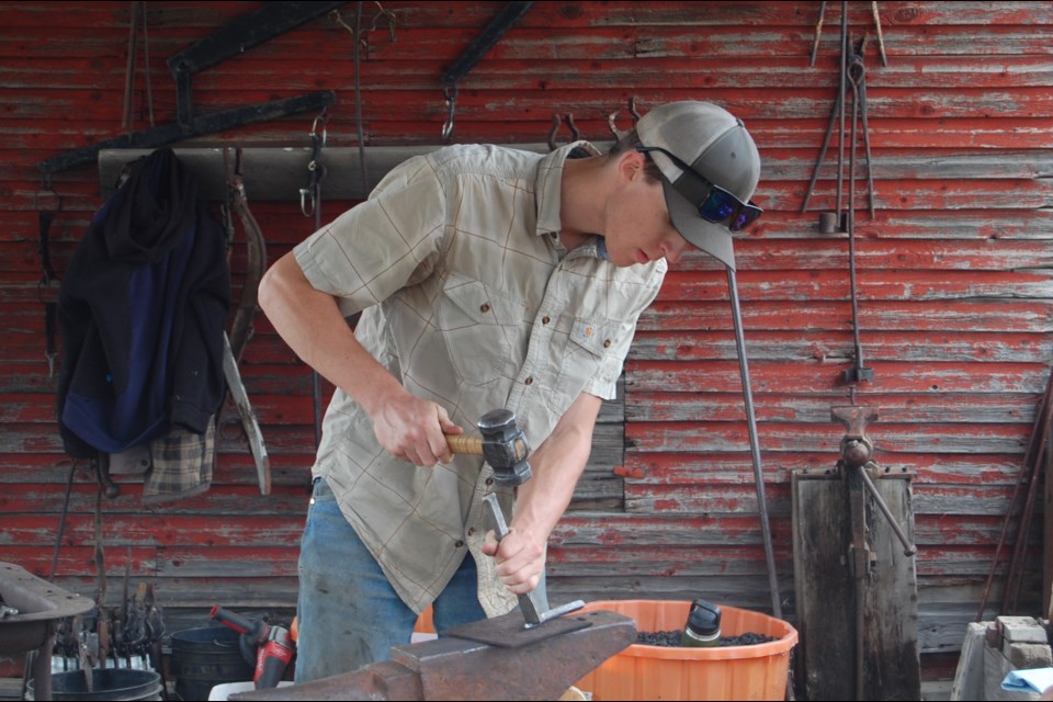 Gus Wightman, a local teen, demonstrates coal forging. Wightman started forging when he was 12 years old.