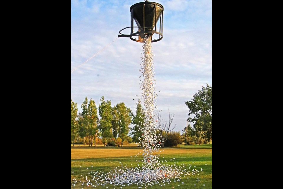 About 4,200 golf balls dropped out of the big bucket, suspended by a crane, and the first three into the hole won the top cash prizes in the Weyburn-Estevan Rotary Golf Ball drop on Saturday evening.