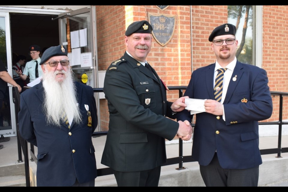Estevan legion president Jim (Frosty) Forrest, left, and first vice-president Tyson Wilhelm, right, presented a cheque for $6,000 to Craig Bird with the Army Cadets. 
