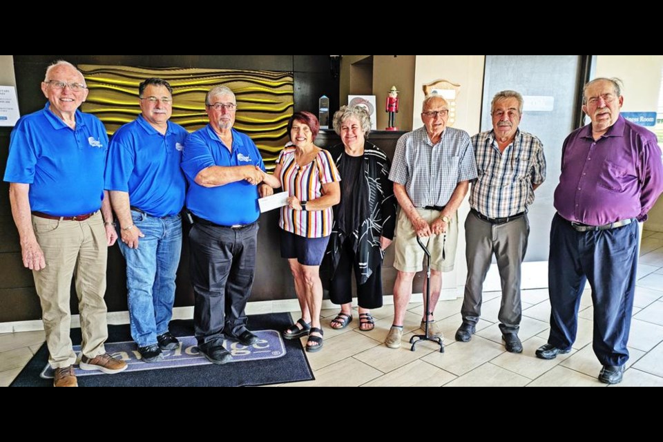 The Travelodge charity golf tournament committee presented a donation of $14,185 to Jackie Wilson of Inclusion Weyburn, proceeds from their 20th and final tournament. From left are Gary Anderson, Brad Wheeler, George Siourounis of Travelodge, Jackie Wilson, Marga Cugnet, Grant Marinos, and Harry and John Siourounis of Travelodge.