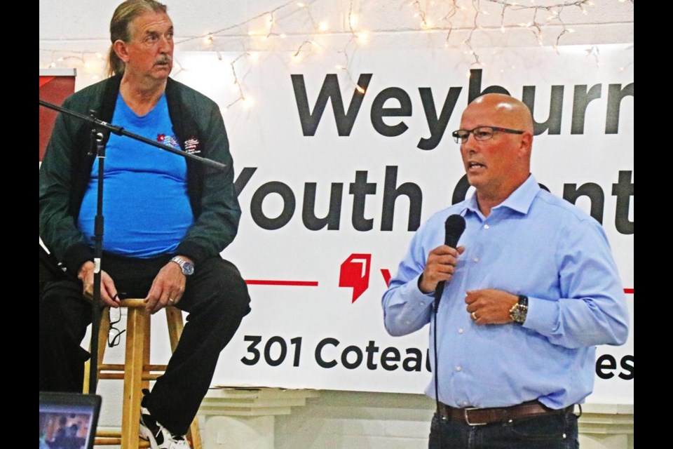 Police chief Jamie Blunden spoke at the Weyburn Youth Centre banquet, as board chair Cam Weber listened at left, at Knox Hall on Saturday.