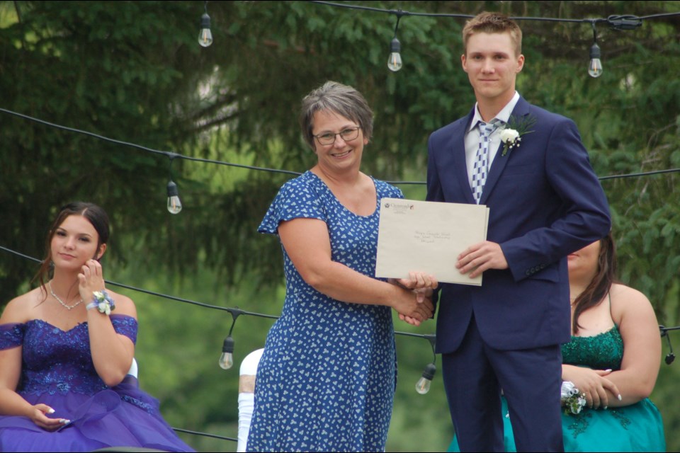 Doreen Bochnuik, left, of the Crossroads Credit Union presented Skylar Ryczak with a scholarship.