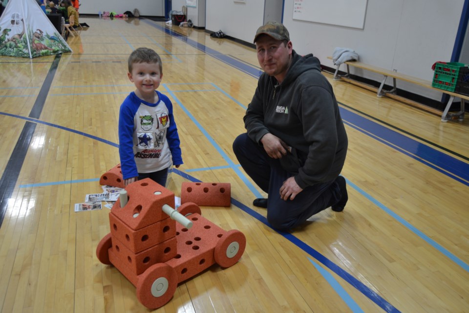 Deklyn Blender and his dad Tyler Blender built a car out of blocks at one of the stations at the IMPACT family program held in Preeceville.