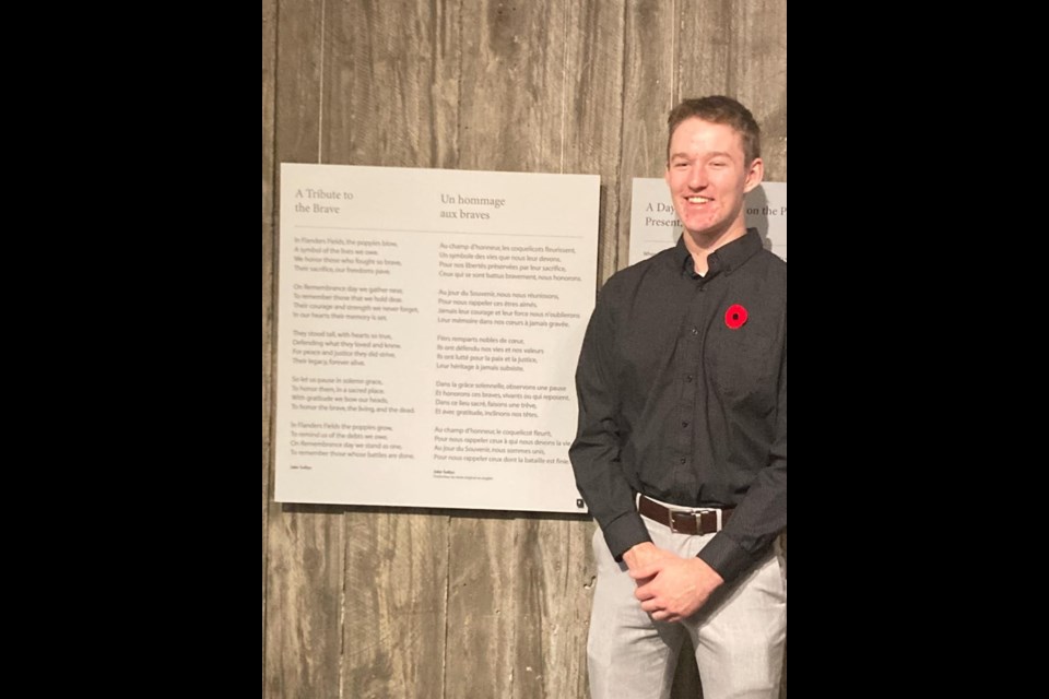 Jake Soltys of Sturgis beside his national award-winning Remembrance Day poem that is on display at the National War Museum for one year in Ottawa.