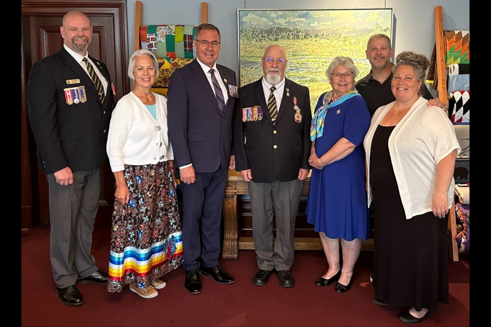 Lieutenant Governor Russ Mirasty and Donna Mirasty with Kenneth Turner and his family, including his sister Patricia Falconbridge and his two children James Turner and Patricia Turner, and Craig Bird, deputy zone commander for the Royal Canadian Legion in southeast Saskatchewan, at the presentation of the Sovereign's Medal for Volunteers.