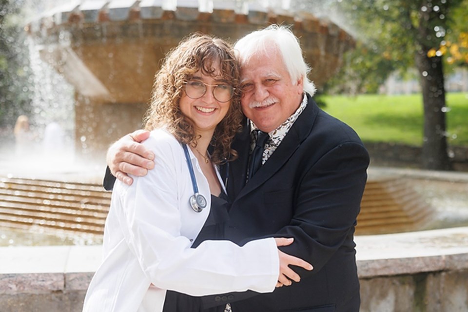 Rory Langelier and her grandfather, Dr. Ken Langelier (DVM'81), share a hug after the WCVM's White Coat Ceremony on Sept. 23. 
