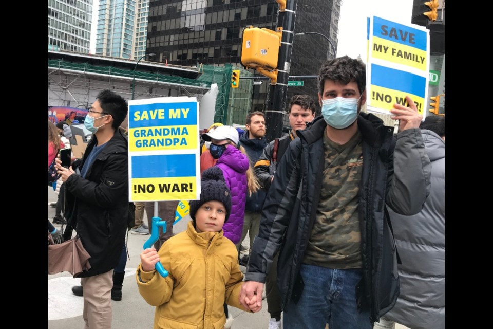 Hryhorii Tymoshenko and his son attend a rally in downtown Vancouver to protest against the war in Ukraine. Tymoshenko worries about his wife and parents, who are there. 