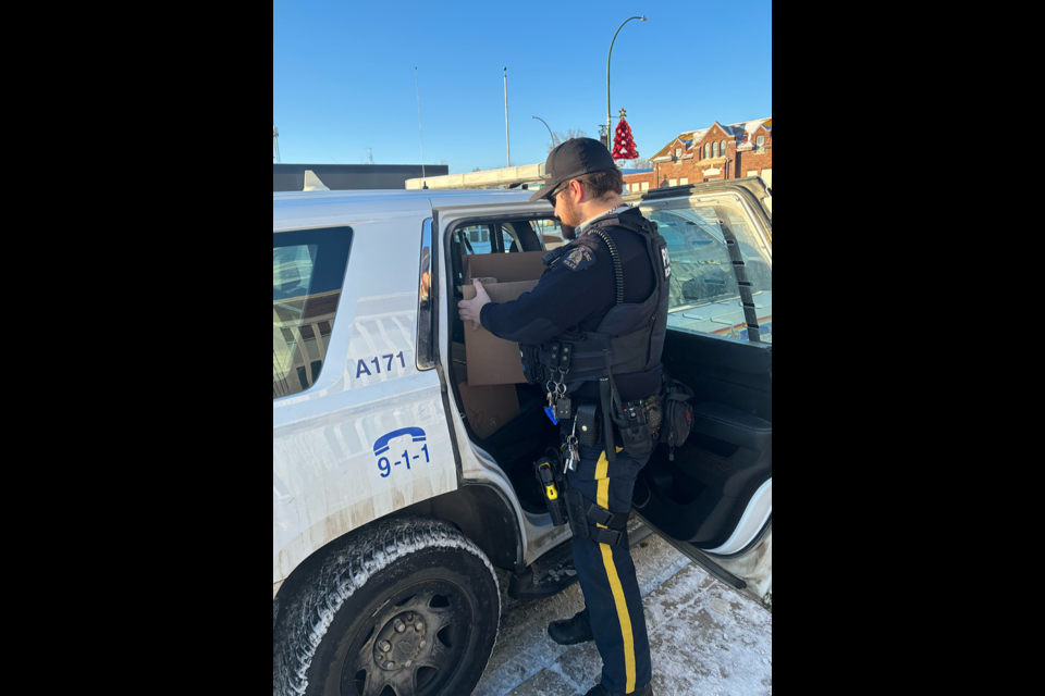 Cst. Clayton Sawatsky of the Canora RCMP detachment visited Filling the Gap Food Bank in Canora in December to assist with Christmas hamper deliveries.