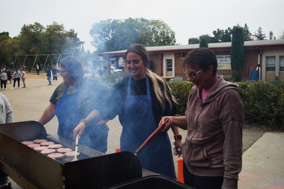 School teachers and staff manning the grill were glad that the gray weather hadn’t turned to rain during the festivities.