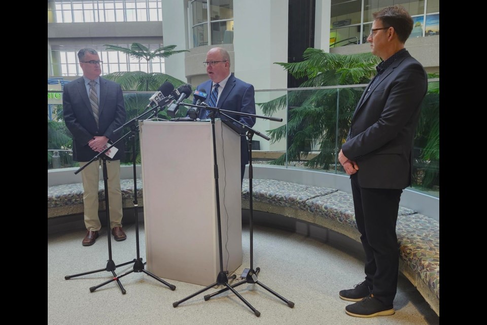 Saskatchewan Health Authority CEO Andrew Will, centre, answers questions from local media. At the same time, Integrated Saskatoon Health Vice President John Ash and SHA Physician Executive Dr. Mark Fenton listen on Friday, March 7, at the SHA Corporate Office inside the Saskatoon City Hospital.