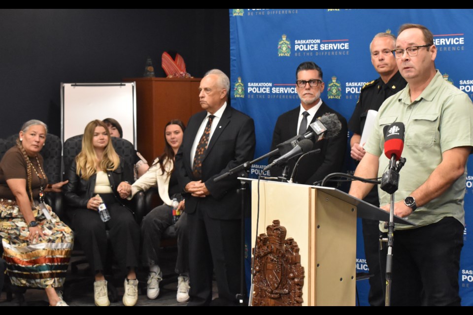 Paul Trottier, right, reads  a statement from the family.