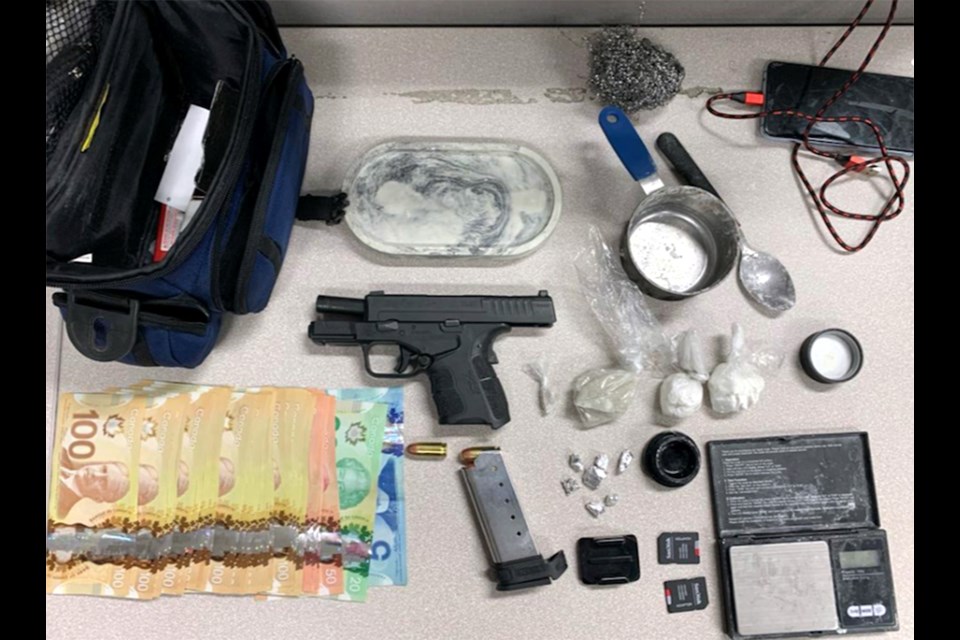 During a search of the vehicle, officers found a semi-automatic handgun, about 56 grams of cocaine, a sum of cash, and drug trafficking paraphernalia.