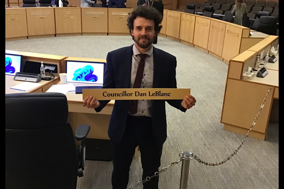 Councillor Dan LeBlanc holds up his council nameplate which he will take home after wrapping up his time on council.