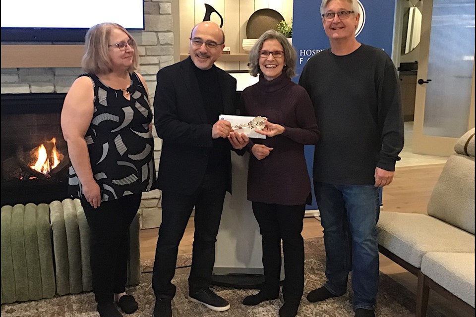 Accepting the grand prize is Leona Baun of Pilot Butte, who shares her winning ticket with her husband Bruce (right) and sister Sherry Langston (left). Presenting the key to the showhome is Dino Sophocleous, President and CEO of Hospitals of Regina Foundation