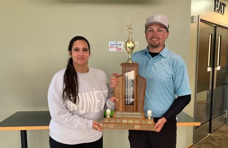 Mitchell Matichuk, right, accepts the FrameTech Classic men's championship trophy from Hannah Battersby. 