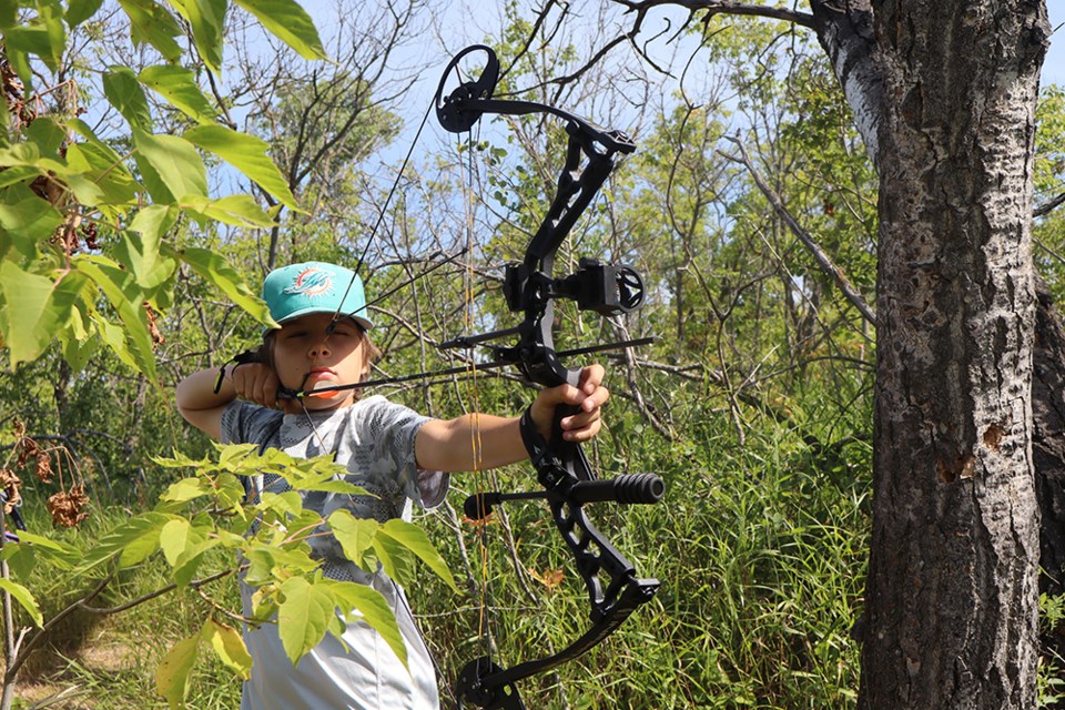 Aidyn Tratch of Canora found a good spot to shot from in among the trees and other vegetation at the Assiniboine River Archery Club 3D shoot on Aug. 11-12 at the Lapitsky farm east of Canora. 