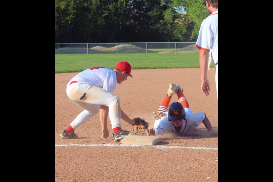 Cardinals’ third baseman Rob Cey was able to tag North Battleford Beavers’ Connor Neave before Neave’s hand touched the base. Looking on is Bryce Gatzke of the Beavers.