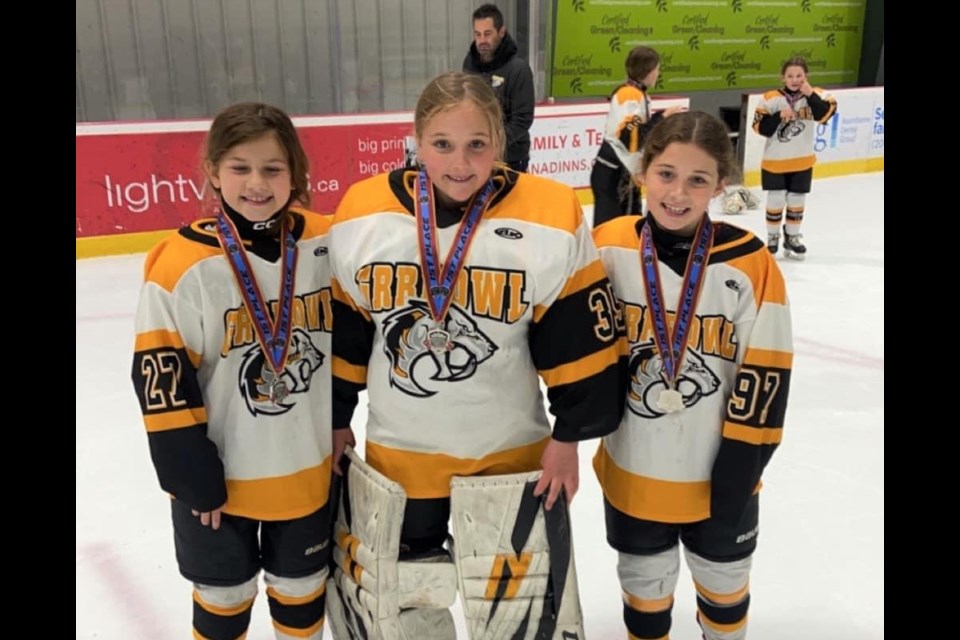 Abigail Jutras, Madelyn Stead and Zyla Hammett won gold with the Grrrowl. 