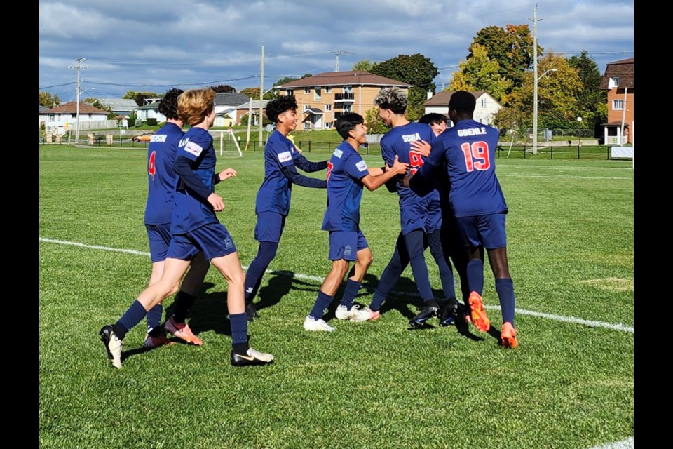 Astra Soccer Academy players celebrate Johan Soria's goal in their game against St. John's Soccer Club in the Canada Soccer Toyota National Championships on Thursday, Oct. 10, at Quinte West, Ontario.