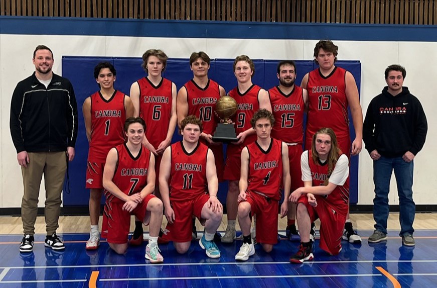 Proudly displaying their league championship trophy, members of the Canora Cougars senior boys basketball team, from left, are: (standing) Kody Rock (coach), Liam Trask, Linden Roebuck, Matthew Makowsky, Briel Beblow, Andrew Owchar, Kalyn McLaughlin and Hudson Bailey (coach); and (front) Jackson Palagian, Jordan Makowsky, Andrew Sliva and Serin Crane.