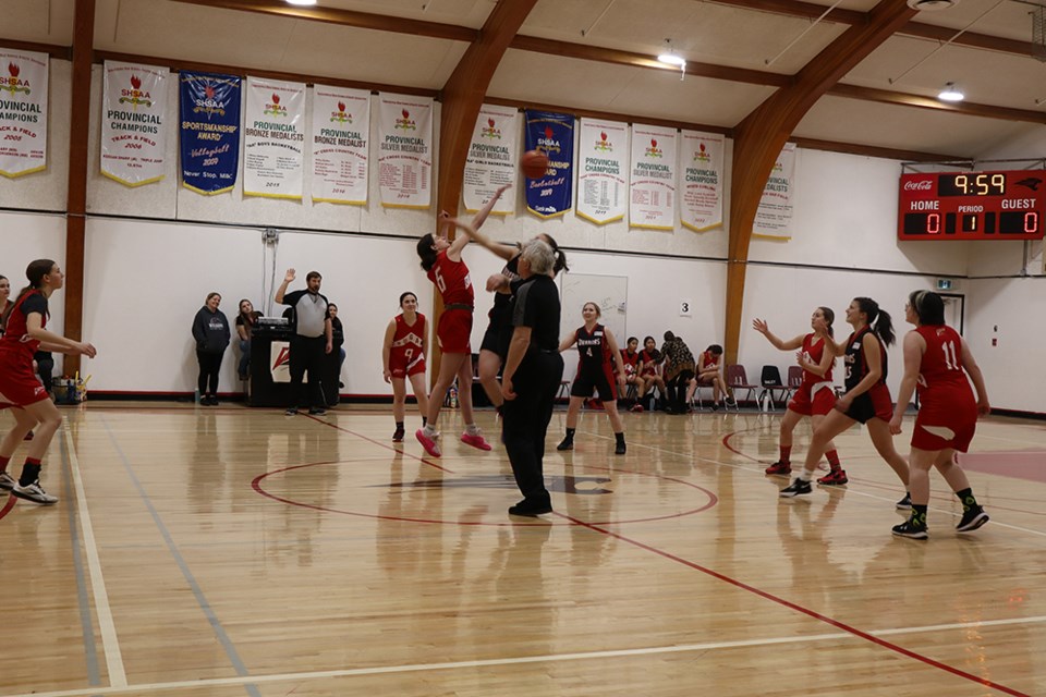 Falyn Ostafie of the Canora Composite School Cougars senior girls basketball team (red jerseys) controlled the tip to start the game against the visiting Esterhazy Warriors on Feb. 12, a 39-34 win for the Cougars. Other Canora players starting the game, from left, were: Josie Mirva, Cairwyn Bailey, Heidi Mentanko, and River Crane. 