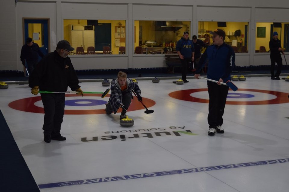 The friendly competition was fierce at the Town & Country Bonspiel held at the Sylvia Fedoruk Centre from January 26 to 29. Sweepers Robin Ludba (left) and Bryan Kolodziejski were ready if needed for this rock released by Joey Palagian. See next week’s Canora Courier for more photos and complete results. / Rocky Neufeld