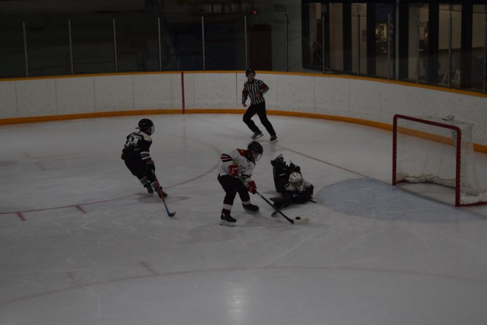 Zarin Godhe of the Canora Cobras (white jerseys) deked around the Yorkton UCT Terriers goalie and went on to score three goals in the A final game of the U11 tournament hosted by the Cobras. Yorkton skated to an 11 to 5 win.